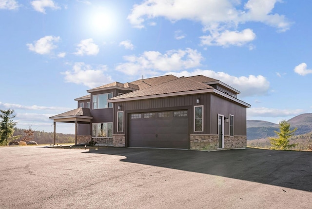 view of front facade featuring a mountain view and a garage