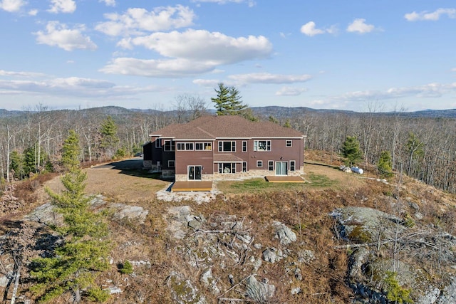 rear view of property with a deck with mountain view