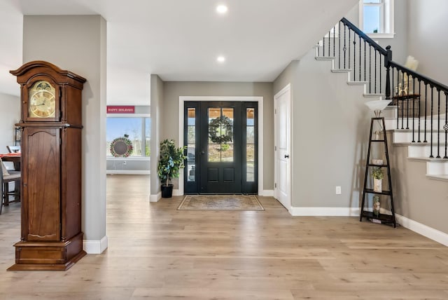 foyer entrance with light hardwood / wood-style floors