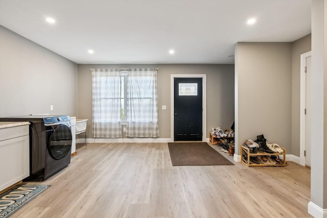 foyer featuring light hardwood / wood-style floors and washer / clothes dryer