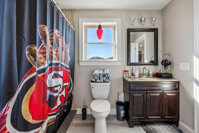 bathroom featuring hardwood / wood-style floors, vanity, and toilet