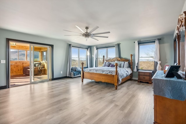 bedroom featuring access to outside, ceiling fan, and light wood-type flooring