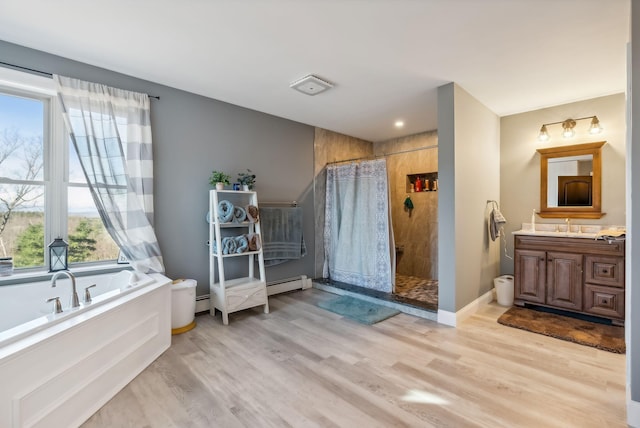 bathroom featuring hardwood / wood-style floors, vanity, independent shower and bath, and a baseboard radiator