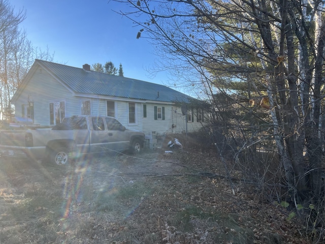 23 Hillcrest Ave, Millinocket, ME 04462 - view of front of home with a chimney and metal roof