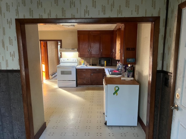 kitchen with baseboard heating, electric stove, sink, and exhaust hood