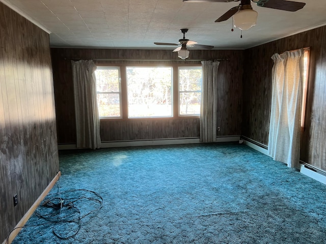 carpeted spare room with ceiling fan and wooden walls