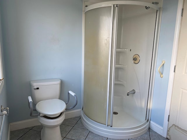 bathroom featuring tile patterned floors, an enclosed shower, and toilet