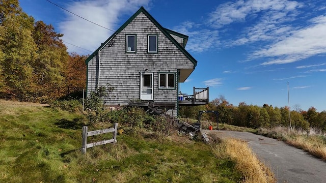 view of side of property with a wooden deck