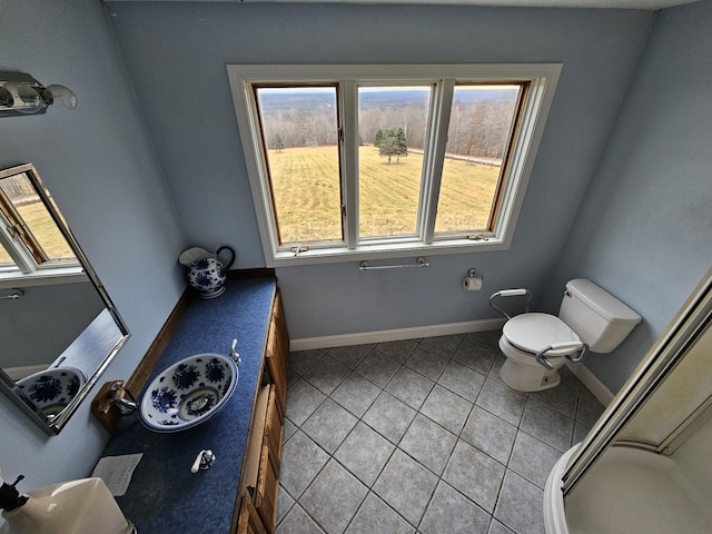 bathroom with tile patterned flooring, vanity, and toilet