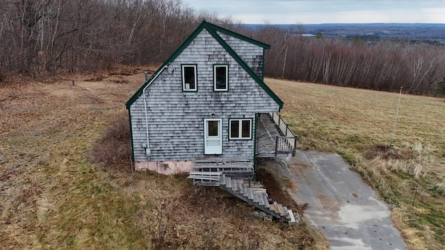 view of side of home with a lawn