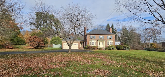 colonial-style house with a front lawn and a garage