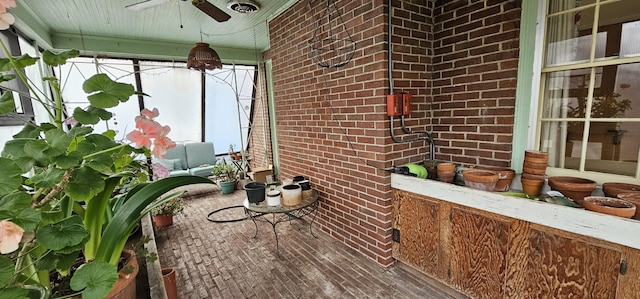 unfurnished sunroom with ceiling fan