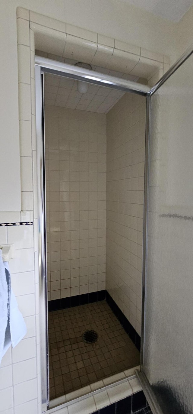 bathroom with a tile shower