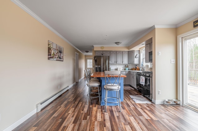 kitchen featuring gray cabinetry, baseboard heating, black appliances, a center island, and dark hardwood / wood-style floors