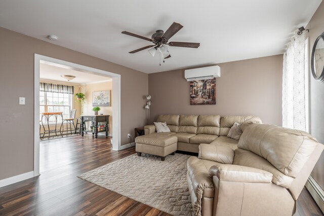 living room with a wall unit AC, ceiling fan, dark wood-type flooring, and a baseboard heating unit