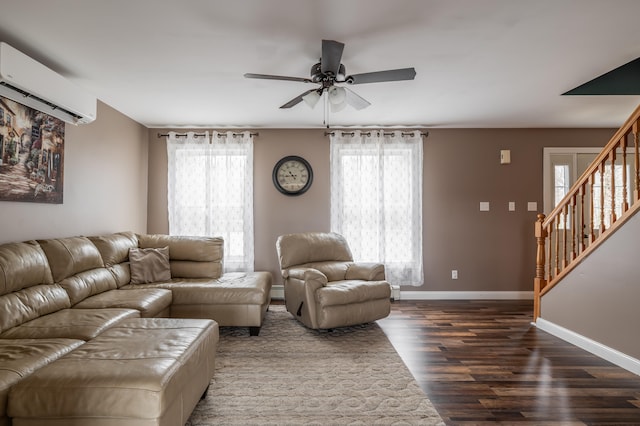 living room featuring a wall mounted air conditioner, ceiling fan, dark hardwood / wood-style flooring, and a wealth of natural light