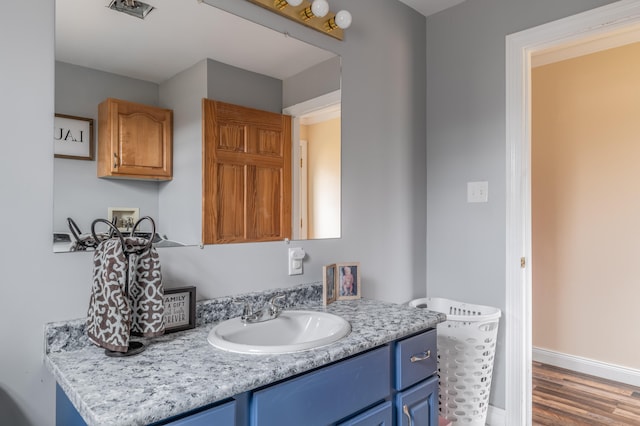 bathroom featuring hardwood / wood-style floors and vanity