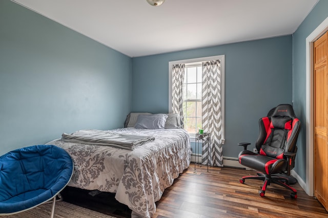 bedroom with dark wood-type flooring and a baseboard radiator