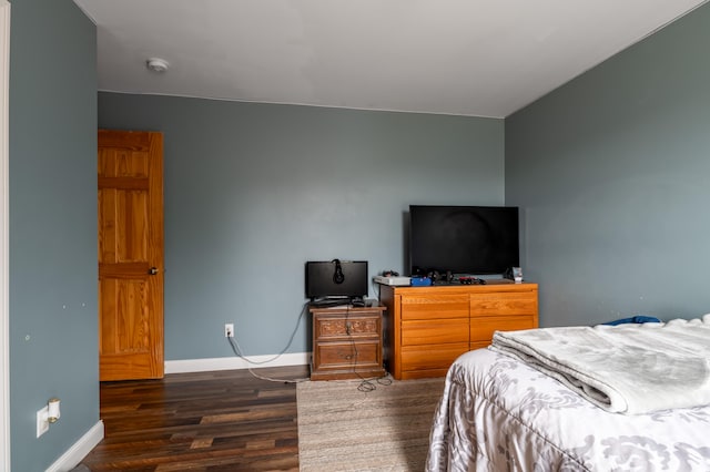 bedroom with dark wood-type flooring