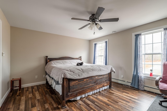 bedroom featuring baseboard heating, ceiling fan, and dark hardwood / wood-style flooring