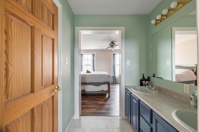 bathroom with ceiling fan, hardwood / wood-style floors, and vanity