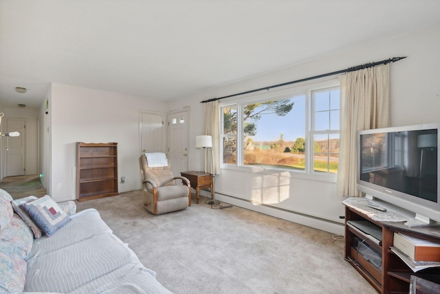 living room featuring light carpet and a baseboard heating unit