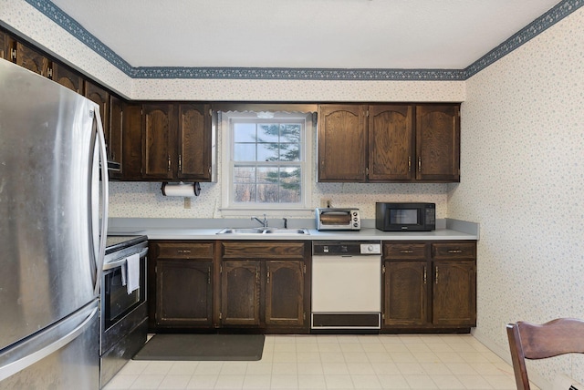 kitchen with sink, dark brown cabinetry, and black appliances