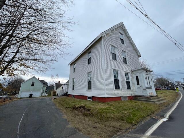 view of side of property featuring an outbuilding and a garage