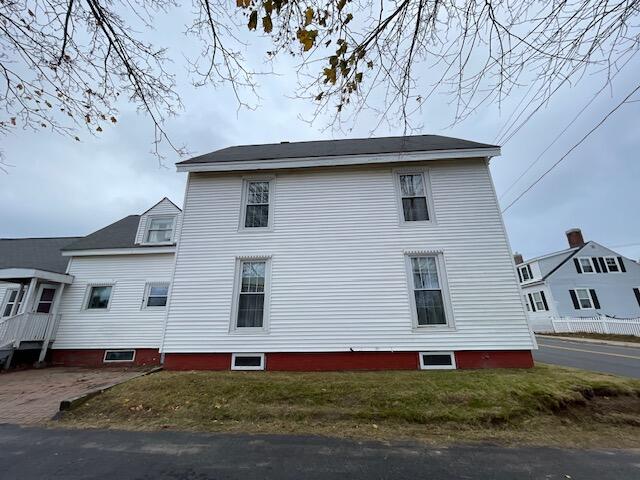 view of side of home featuring a lawn