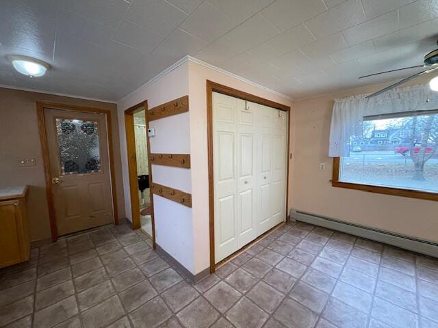 interior space with crown molding and a baseboard radiator