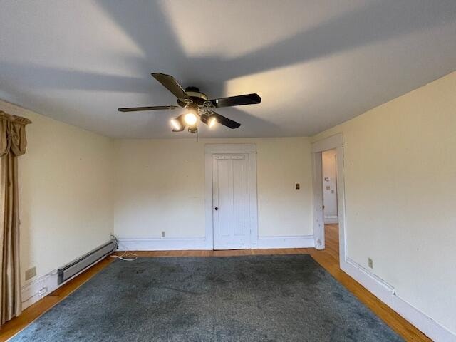 unfurnished bedroom featuring ceiling fan, dark hardwood / wood-style flooring, and a baseboard radiator