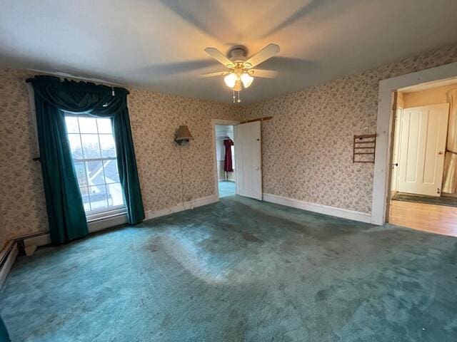 carpeted spare room featuring ceiling fan