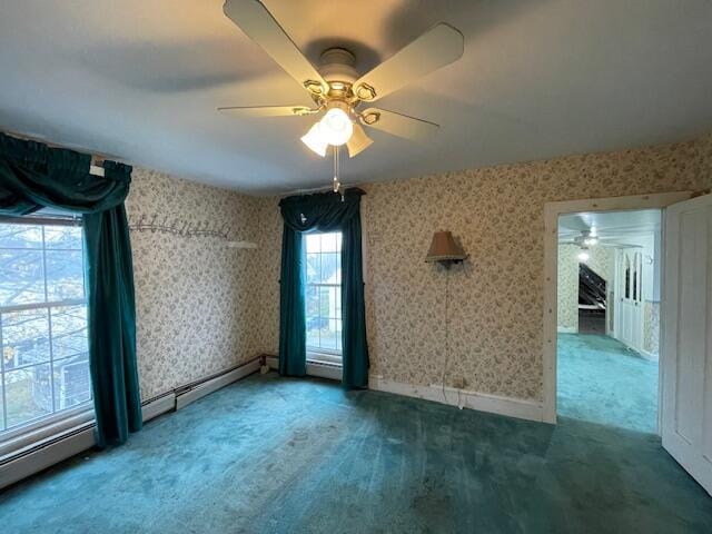 spare room with carpet floors, baseboard heating, and ceiling fan