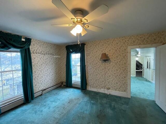 empty room with carpet flooring, ceiling fan, and a baseboard radiator