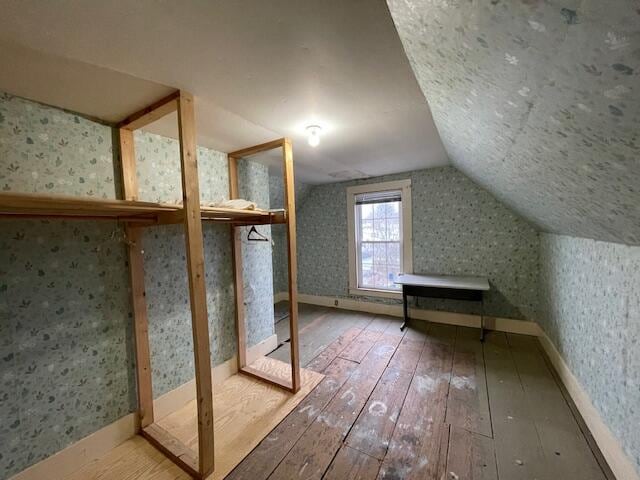 bonus room featuring lofted ceiling and hardwood / wood-style flooring