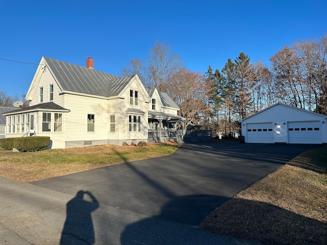 view of side of property with an outbuilding and a garage