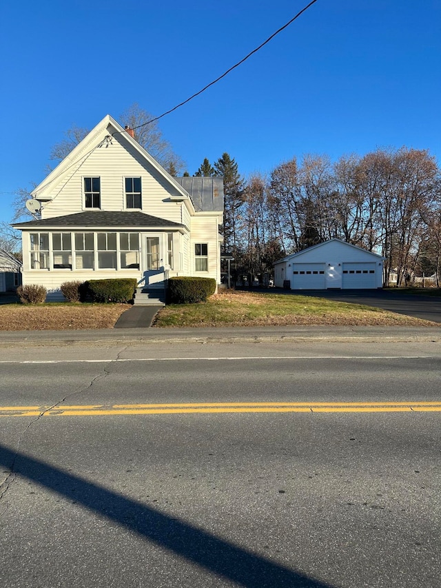 view of front facade with an outbuilding and a garage