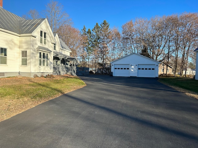 view of side of home with a yard, an outdoor structure, and a garage