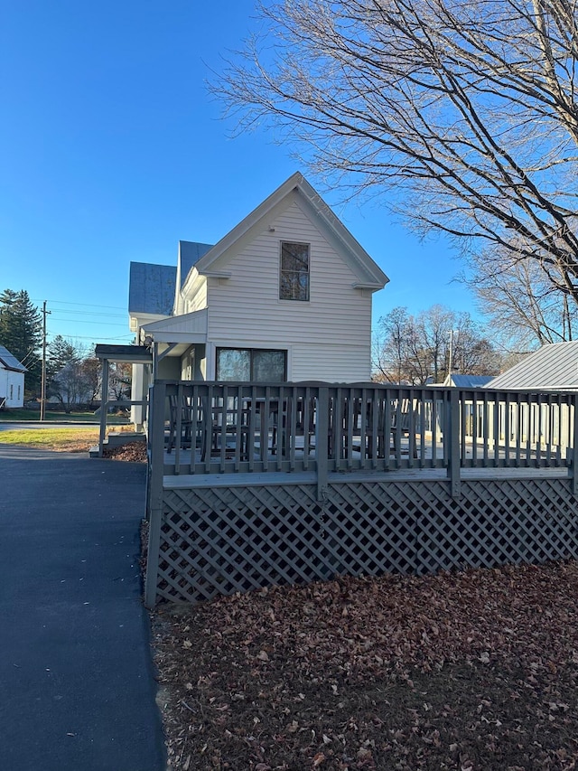 view of side of property with a wooden deck