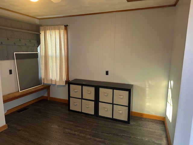 bedroom featuring crown molding and dark wood-type flooring