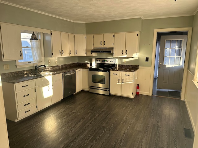 kitchen with dark hardwood / wood-style flooring, white cabinetry, a textured ceiling, and appliances with stainless steel finishes