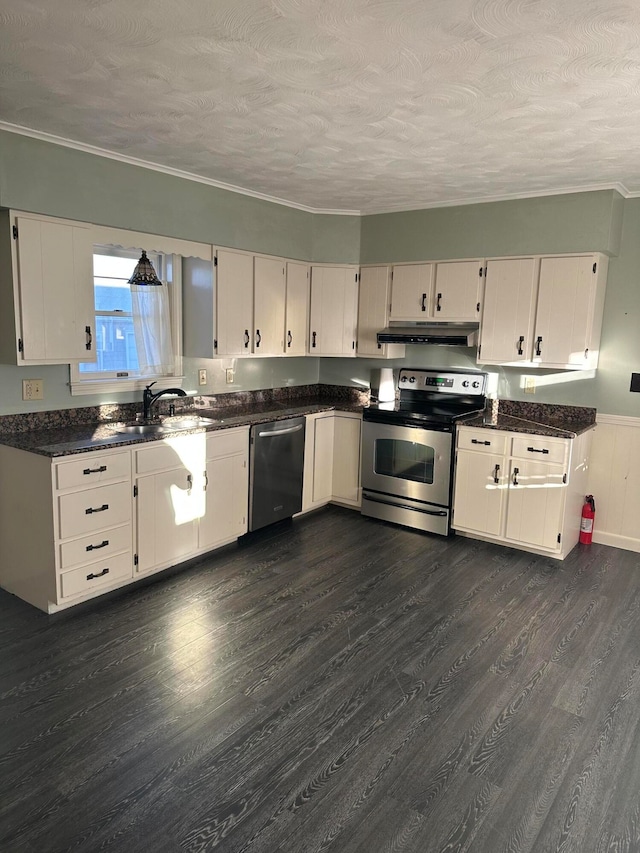 kitchen with a textured ceiling, white cabinets, dark hardwood / wood-style floors, and appliances with stainless steel finishes