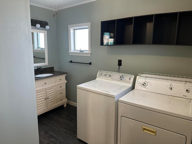 washroom with dark hardwood / wood-style floors, washer and clothes dryer, crown molding, and sink