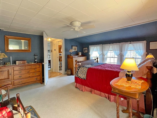 bedroom featuring ceiling fan and light carpet