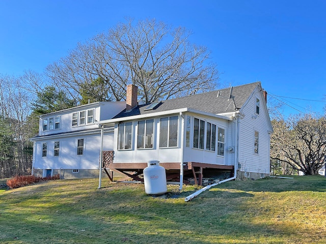 back of house with a lawn and a sunroom