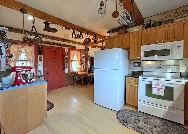 kitchen featuring decorative light fixtures, light hardwood / wood-style floors, and white appliances