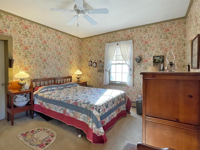 carpeted bedroom with ceiling fan and ornamental molding