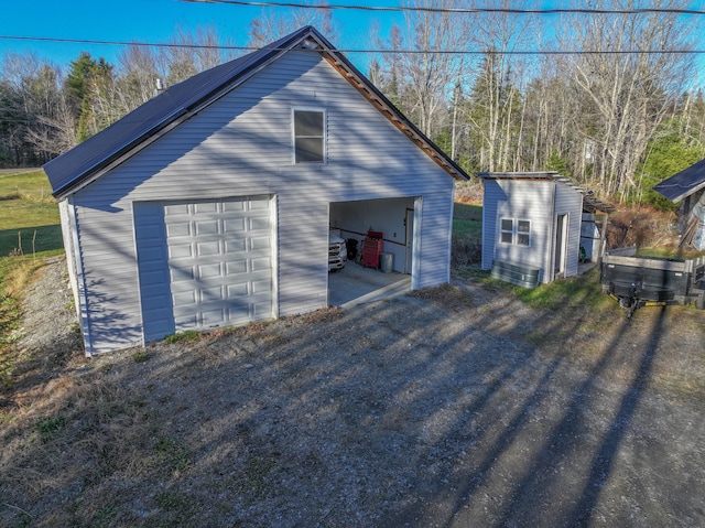 exterior space featuring a garage and an outdoor structure