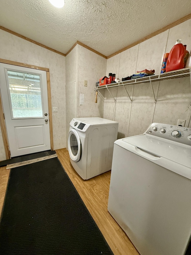 526 Darling Rd, Hudson, ME 04449 - washroom featuring light wood-style flooring, washing machine and dryer, ornamental molding, and a textured ceiling