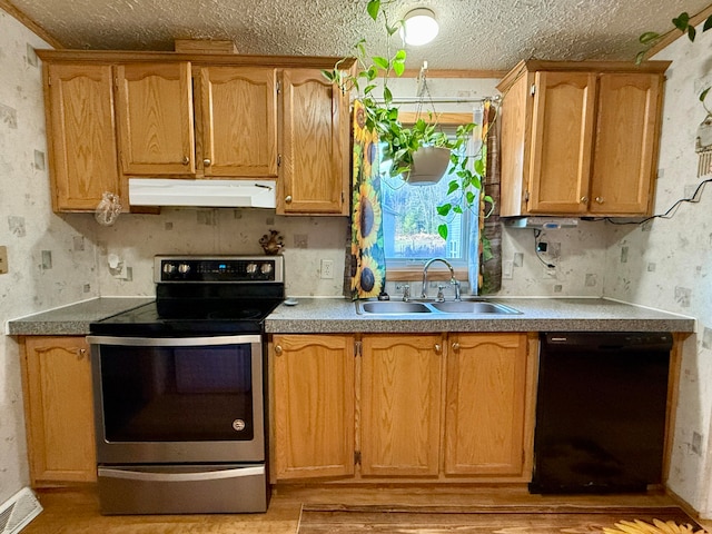 kitchen featuring a textured ceiling, black dishwasher, stainless steel electric range oven, and sink